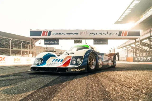 Race car speeding on track at Dubai Autodrome, a premier motorsport destination in UAE.