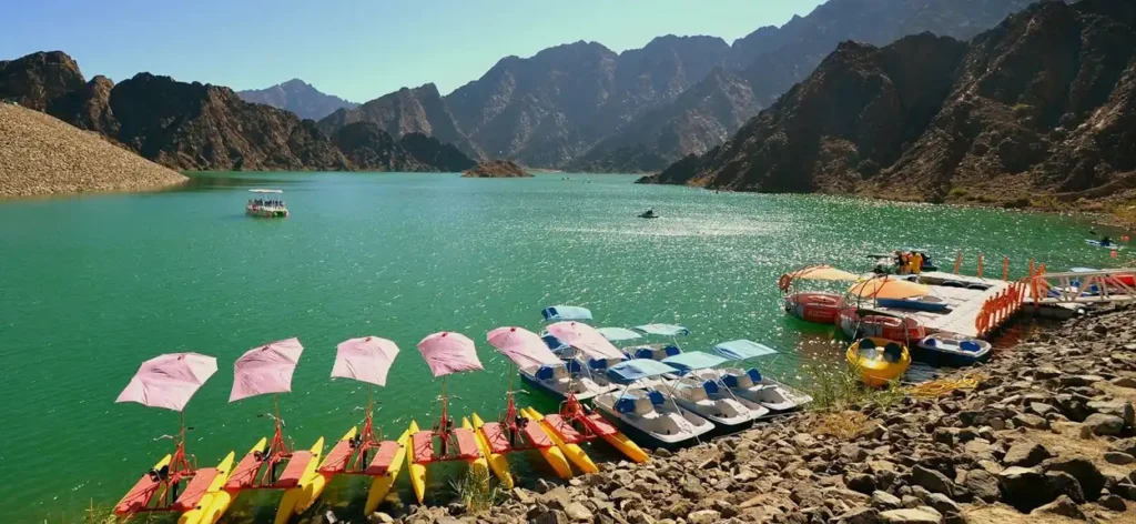 Kayaks on turquoise waters surrounded by scenic Hatta Mountains in Dubai.