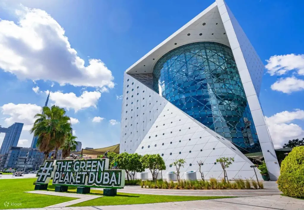 Exterior view of The Green Planet Dubai, a tropical rainforest bio-dome attraction.